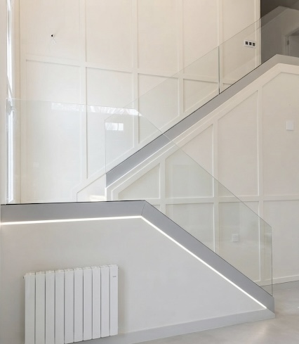Escalera moderna con faldones metálicos y cristal